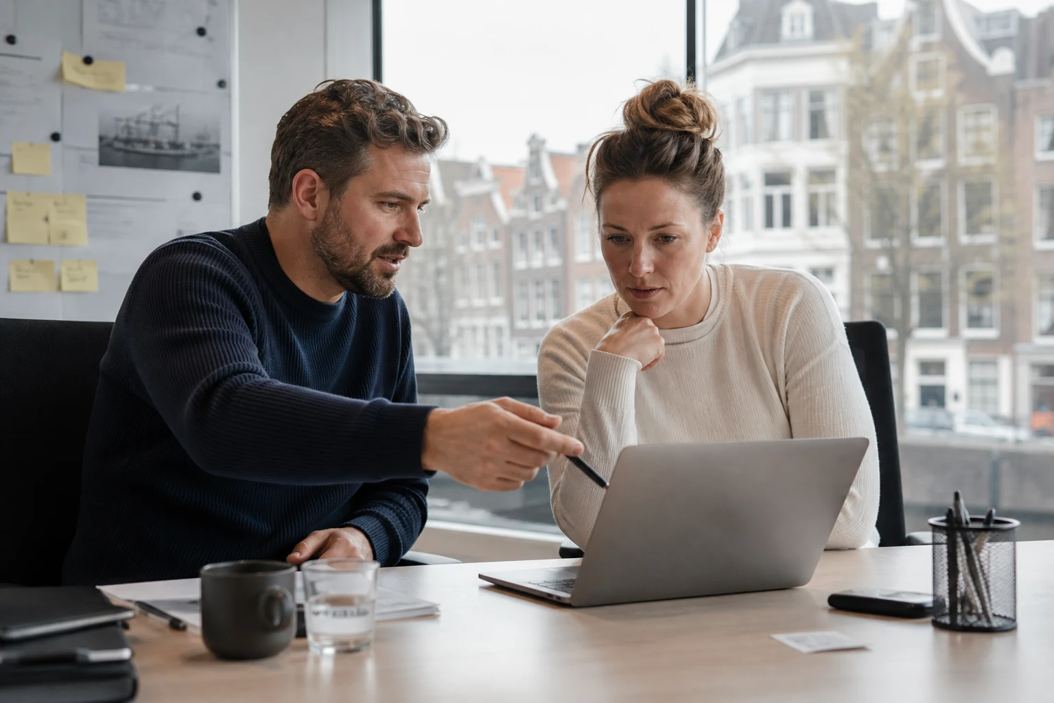Amsterdam logistics colleagues reviewing shipment exceptions and an AI workflow