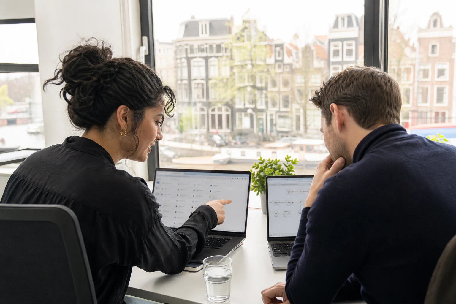 Amsterdam customer-support colleagues reviewing a multilingual service workflow