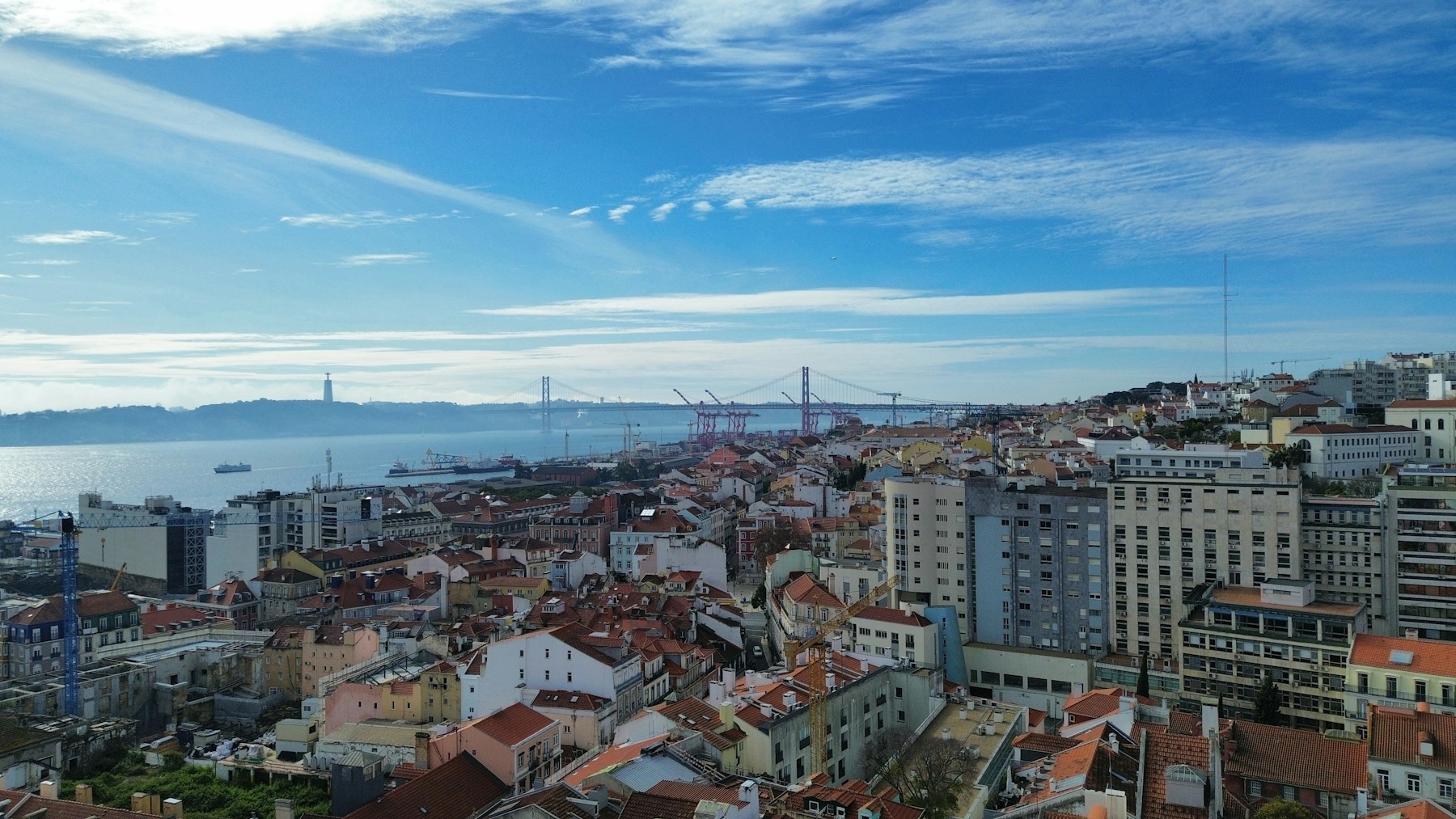 Lisbon city rooftops and the Tagus river photographed from above