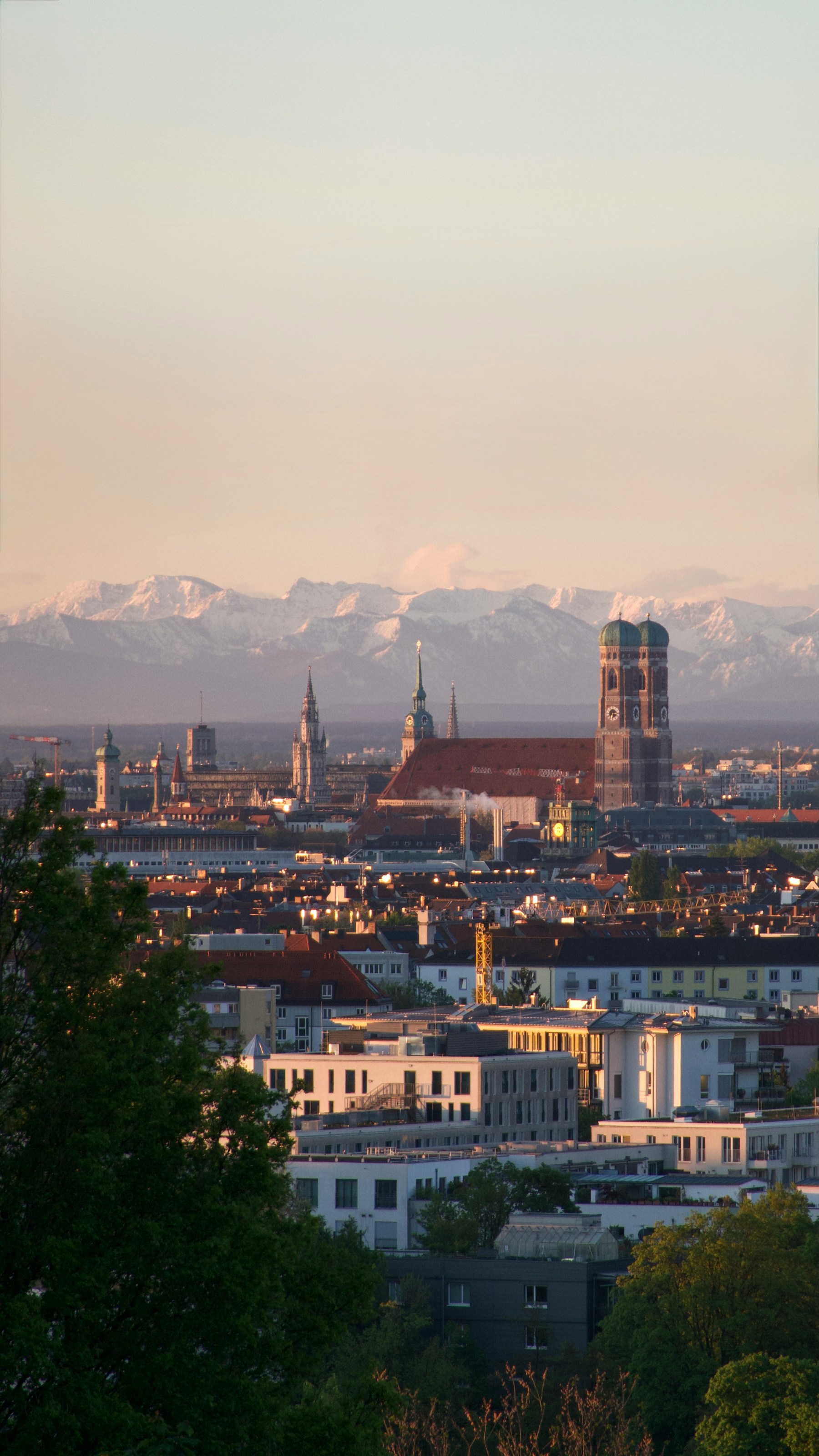 Munich skyline with historic buildings and the Alps in the distance